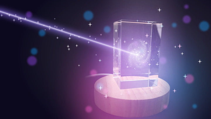 3D laser-engraved galaxy crystal glowing on its LED base