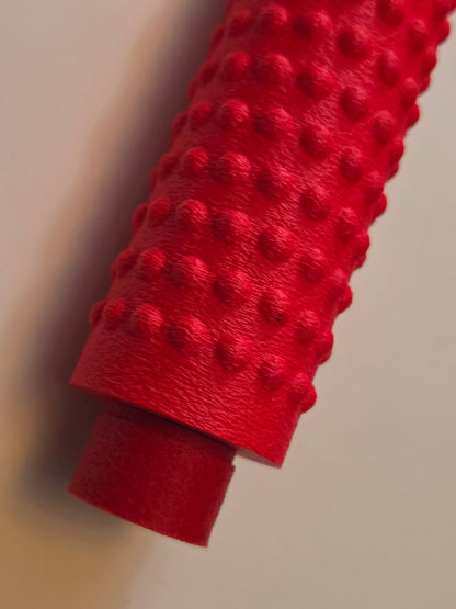 Red massage roller, close-up of the bumps