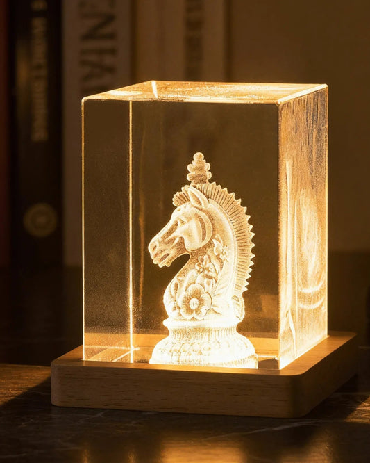Square K9 crystal tower, 5 × 5 × 8 cm, with a 3D-engraved design glowing on a wooden LED base